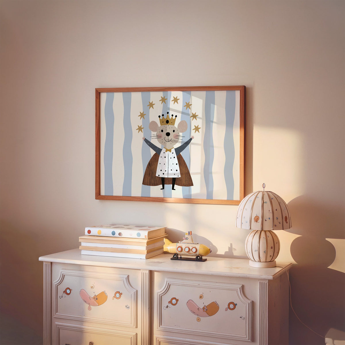 Landscape king mouse crown star arc nursery print in a cherry wood frame above a painted dresser and lamp