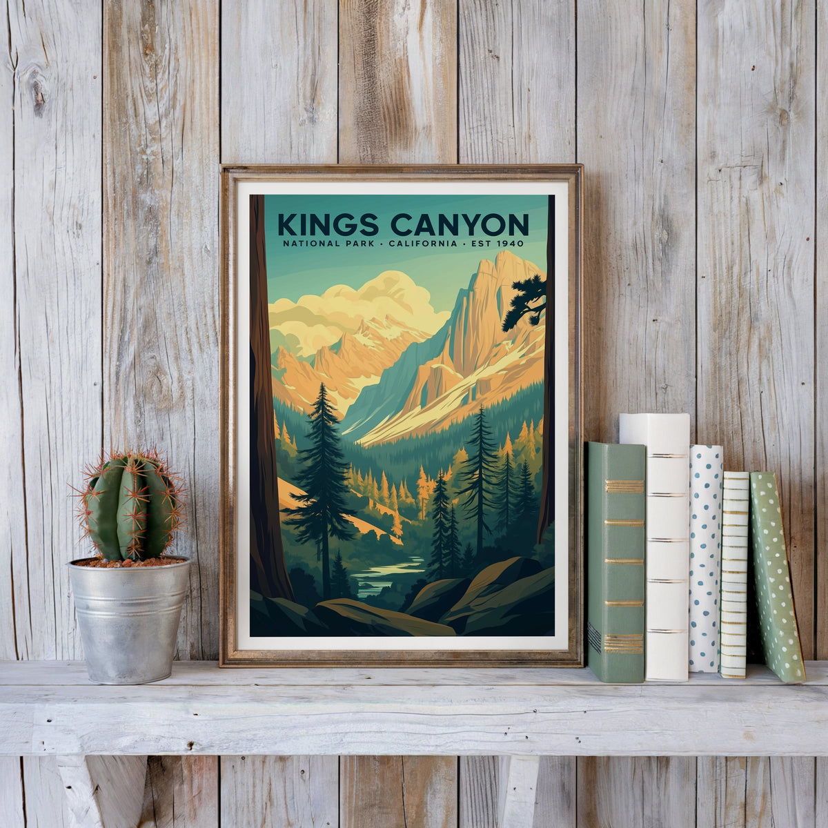 Kings Canyon poster in an antique gold frame against whitewashed farmhouse planks beside books and a cactus