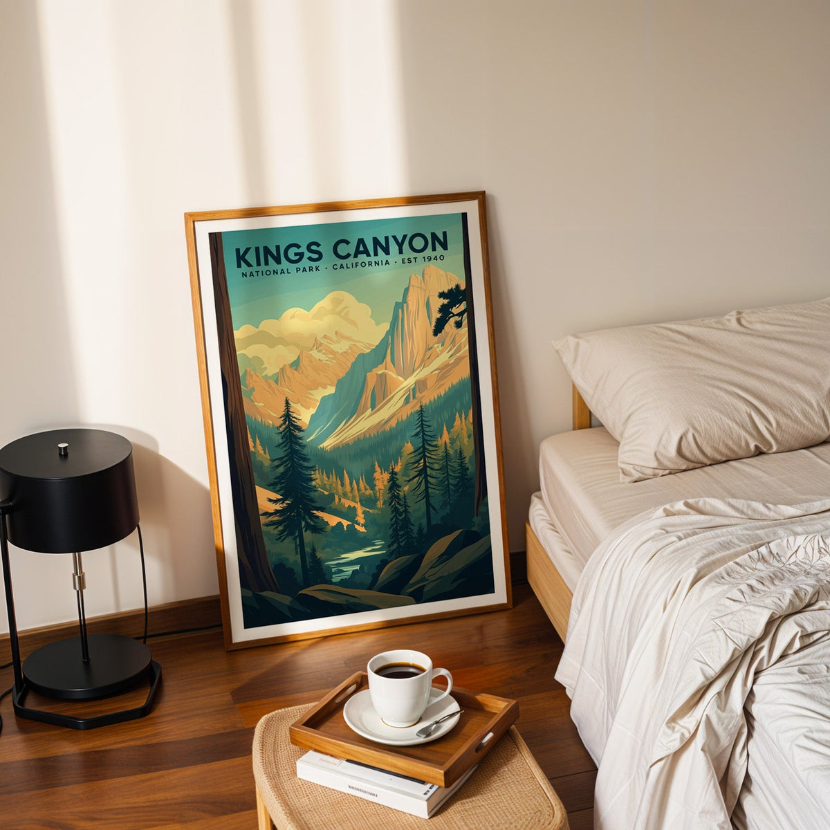 Kings Canyon National Park print in an oak frame leaning on a bedroom floor beside the bed and a coffee tray