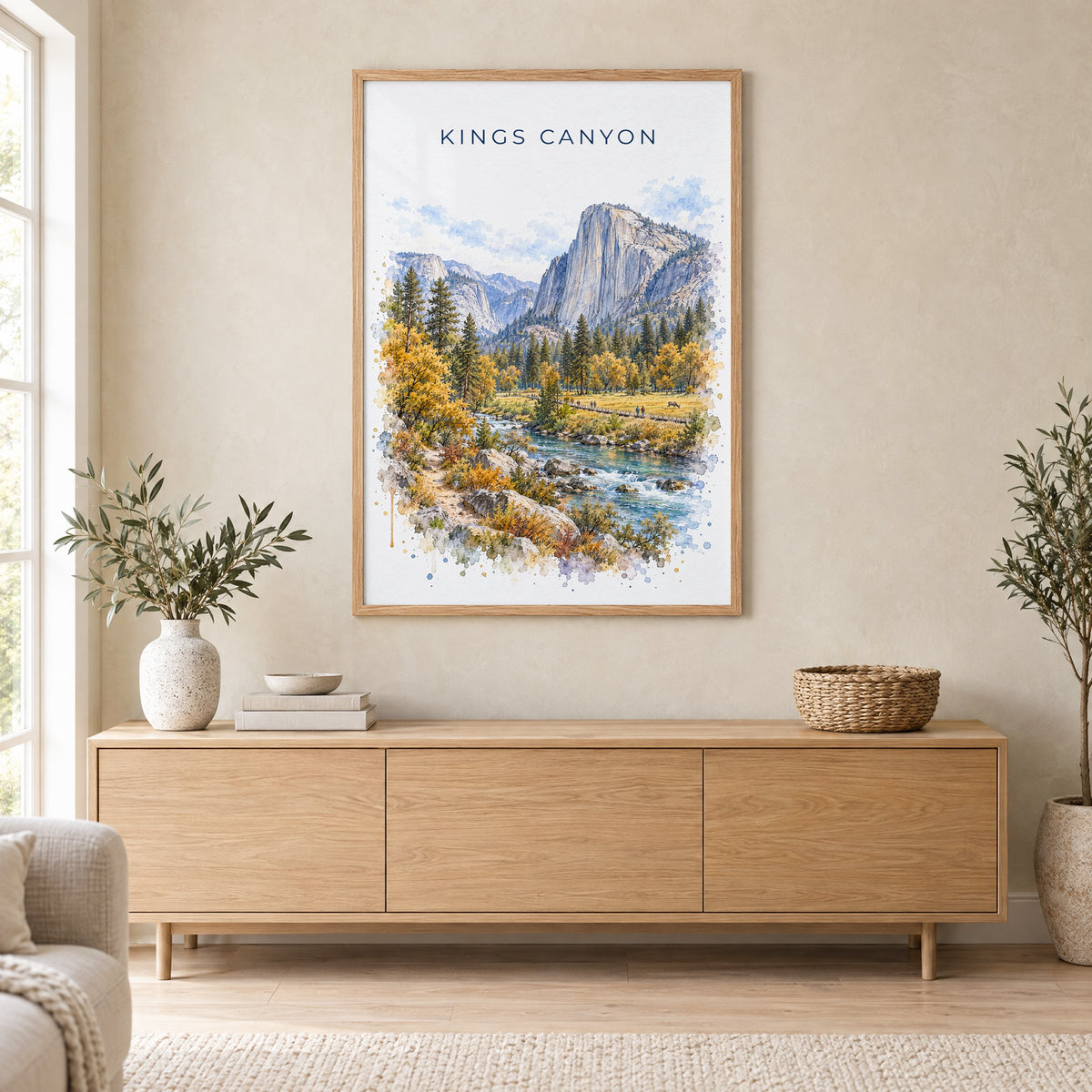 Kings Canyon National Park watercolor print in an oak frame above a light wood sideboard in a Scandinavian living room