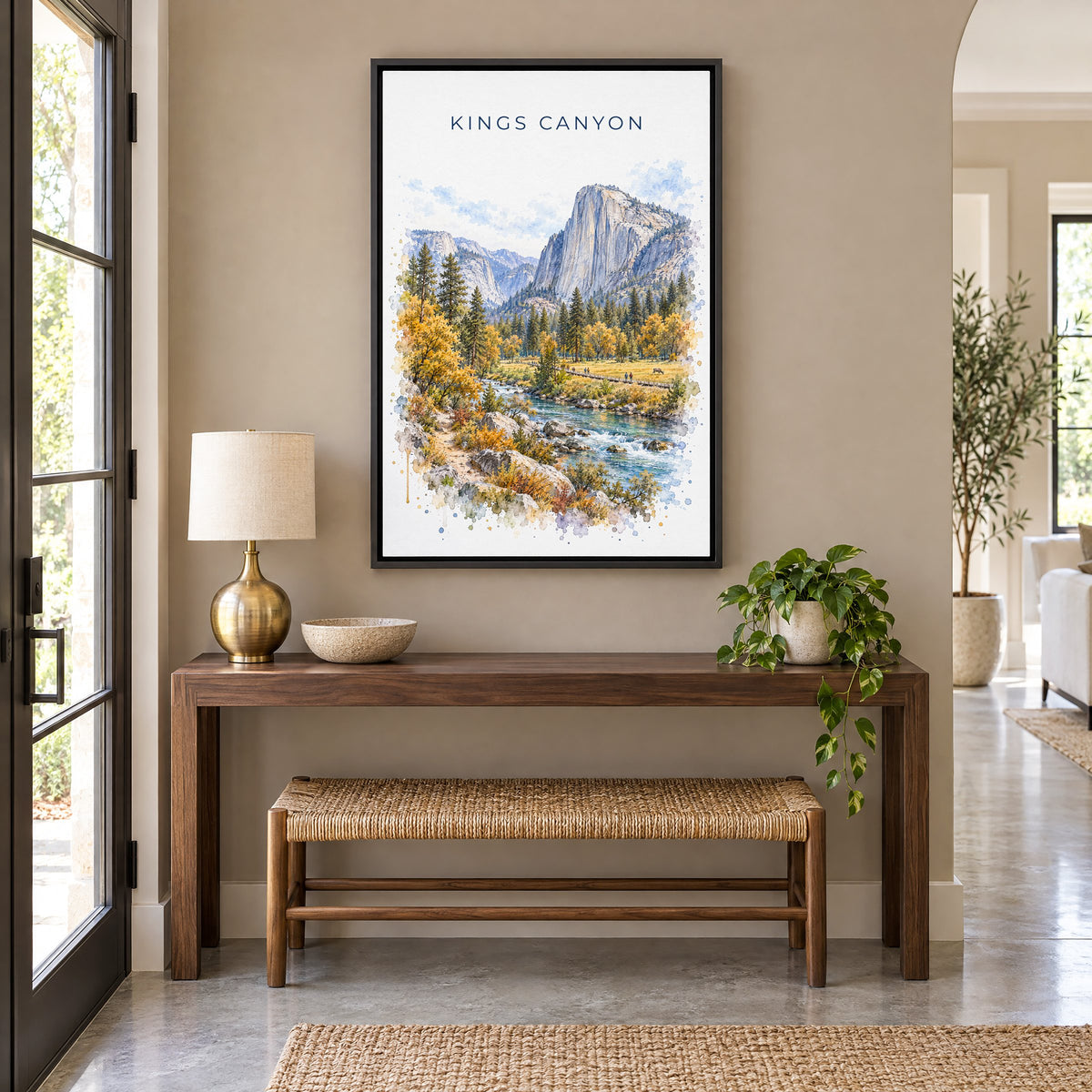 Kings Canyon National Park watercolor print as a black floater canvas above a walnut console and woven bench in an entryway