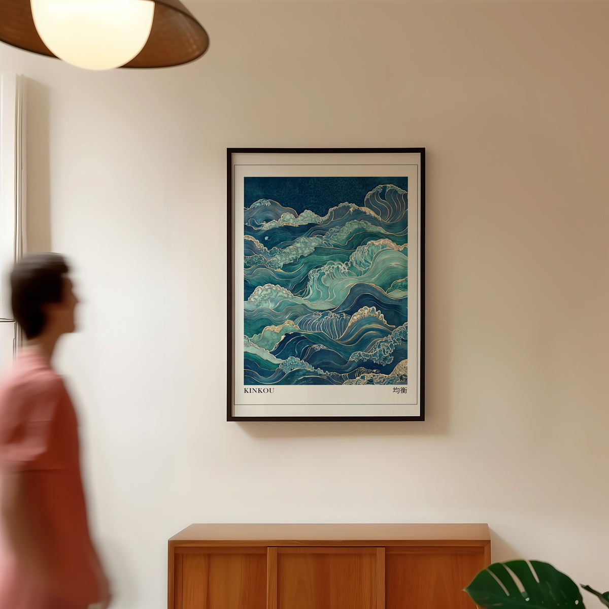 Kinkou teal and gold waves print in a black frame in a hallway under a rattan pendant