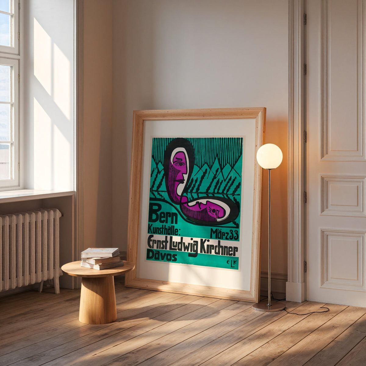 Expressionist poster in a wide pine frame leaning by a sunlit window