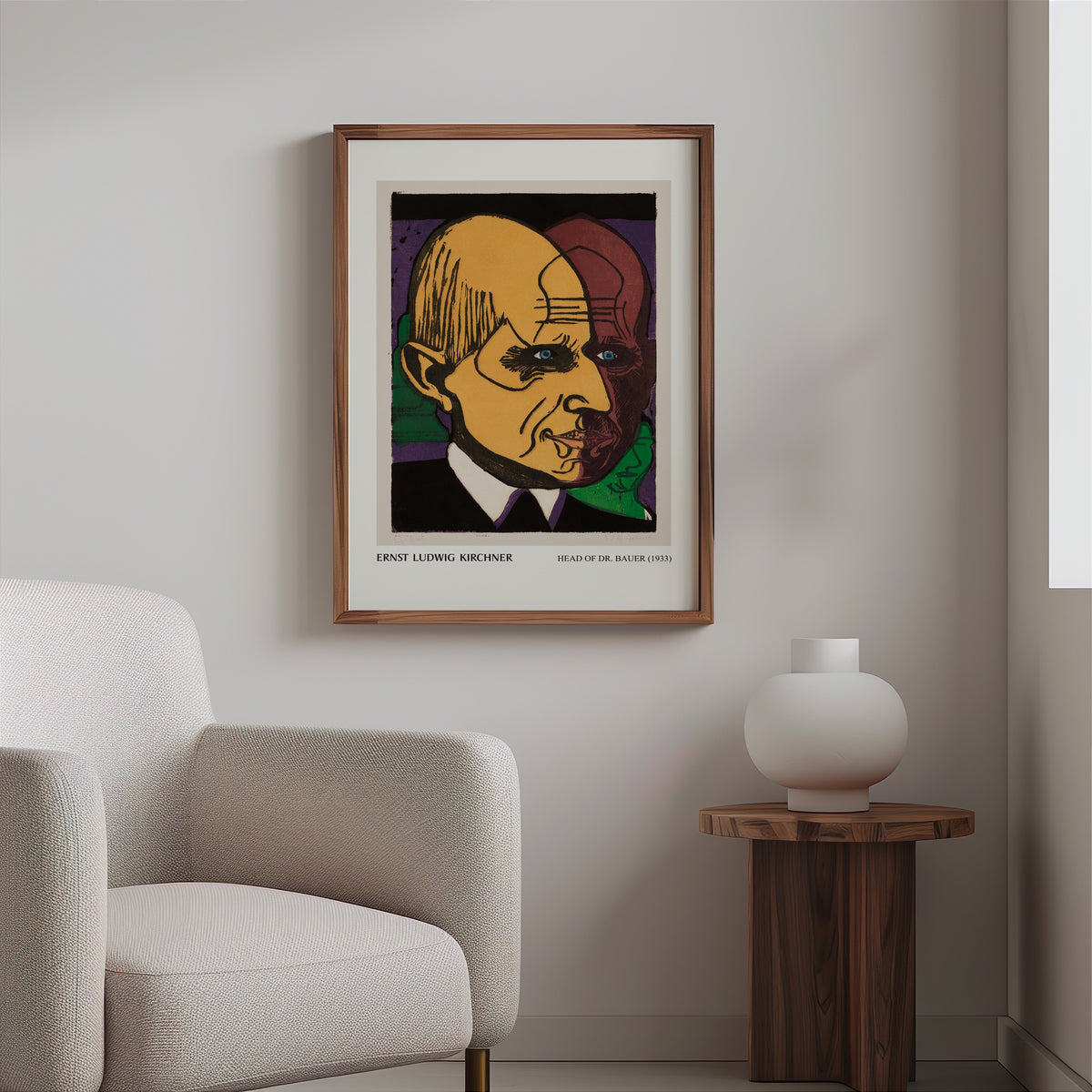 Expressionist portrait print in a slim walnut frame above a bouclé armchair
