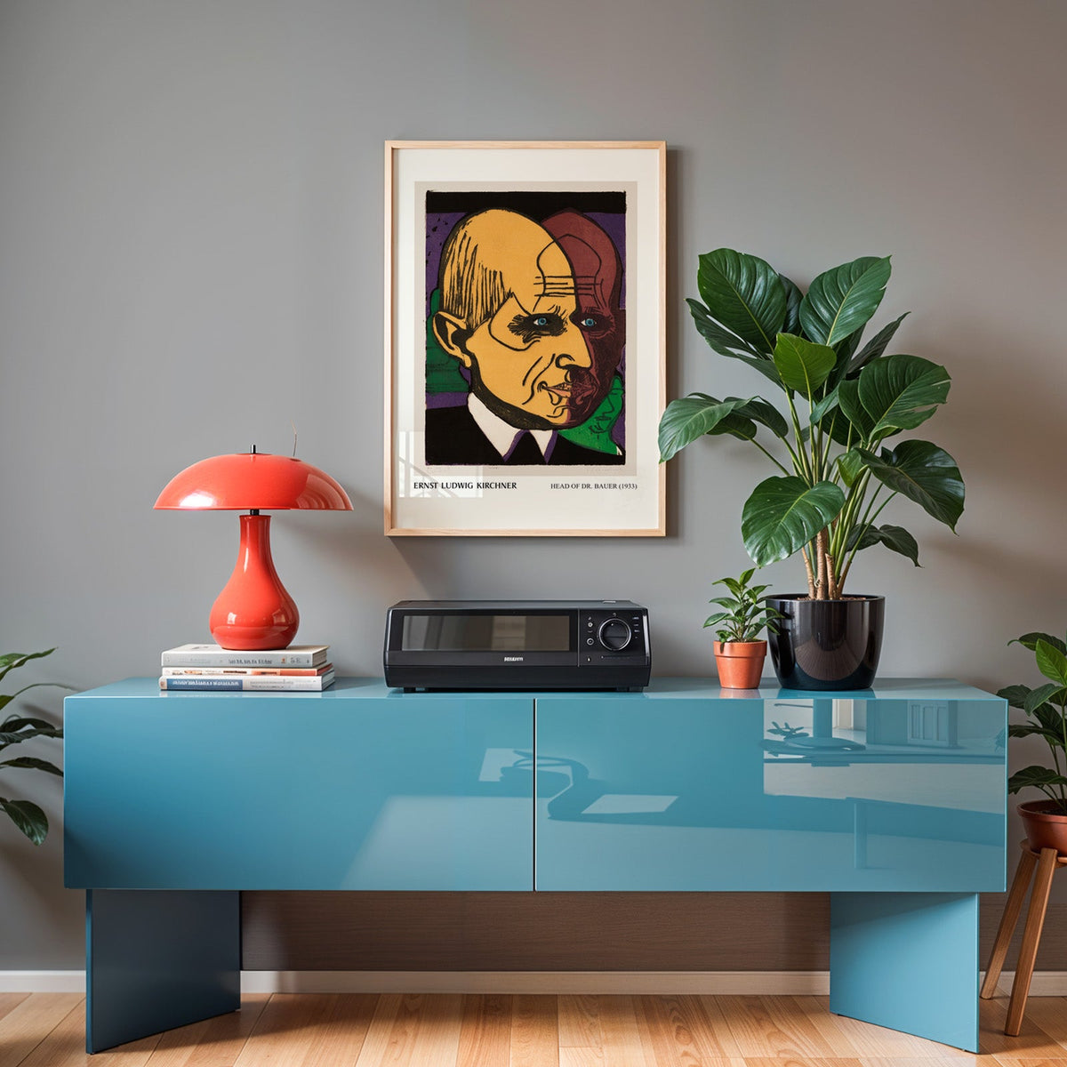 Kirchner portrait in an oak frame above a teal sideboard with a red lamp