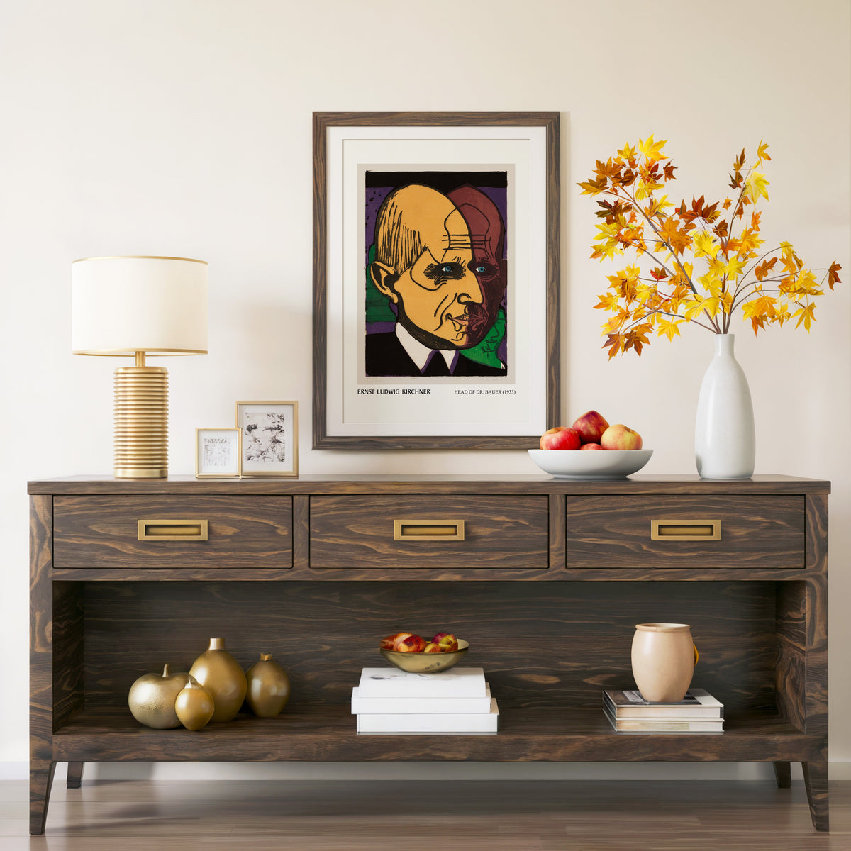 Head of Dr Bauer print in a walnut frame above a console with autumn branches