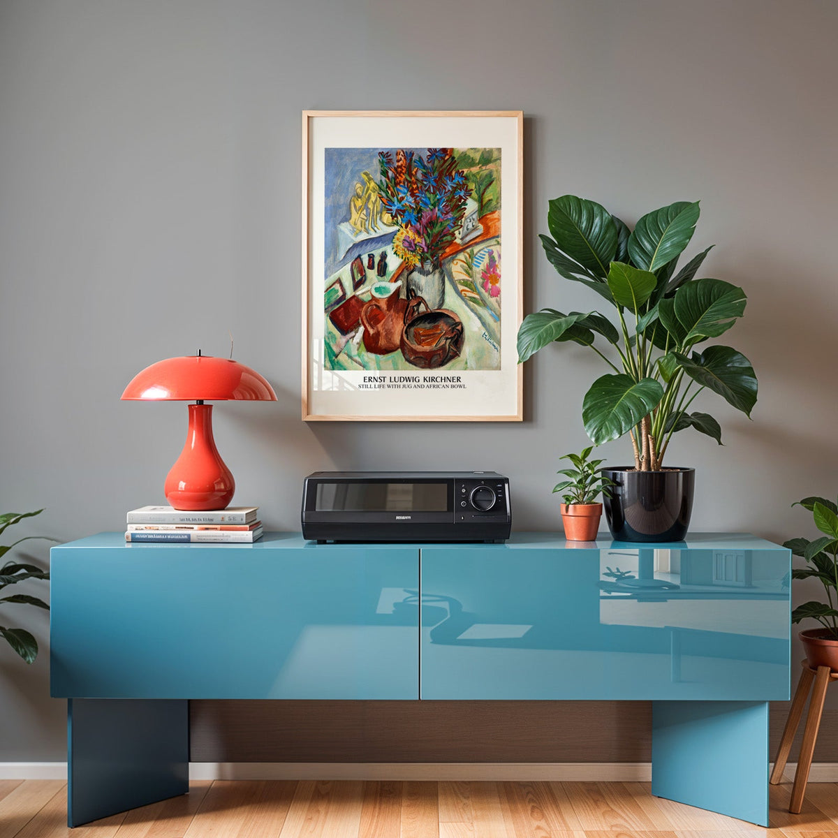 Kirchner flowers print in an oak frame above a teal sideboard with a red lamp