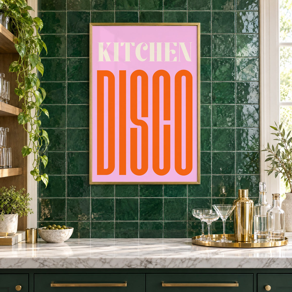 Kitchen Disco pink and orange type print in a brass frame on emerald green tiles above a home bar with coupe glasses