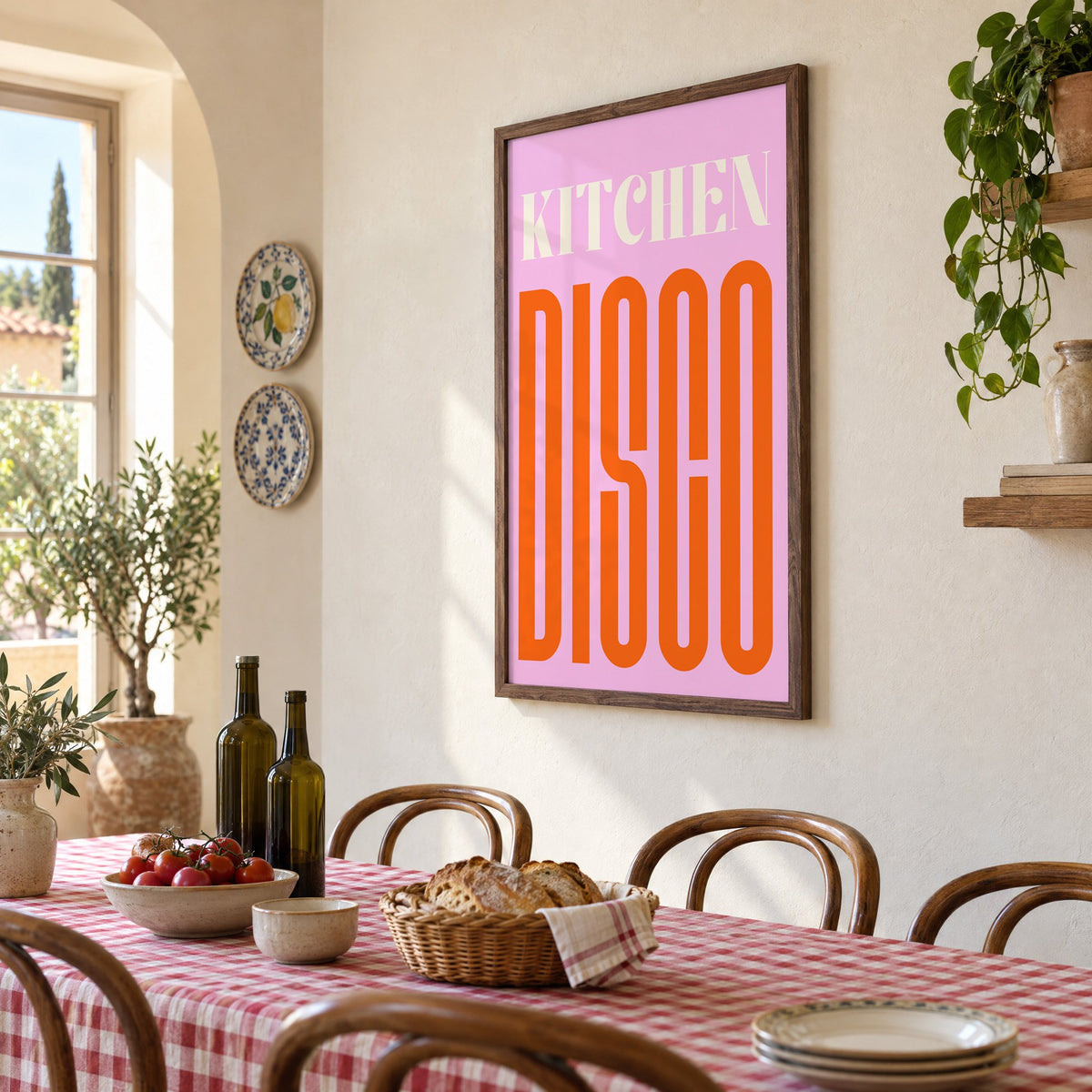 Kitchen Disco pink and orange type print in a walnut frame above a gingham-covered trattoria table, seen at an angle