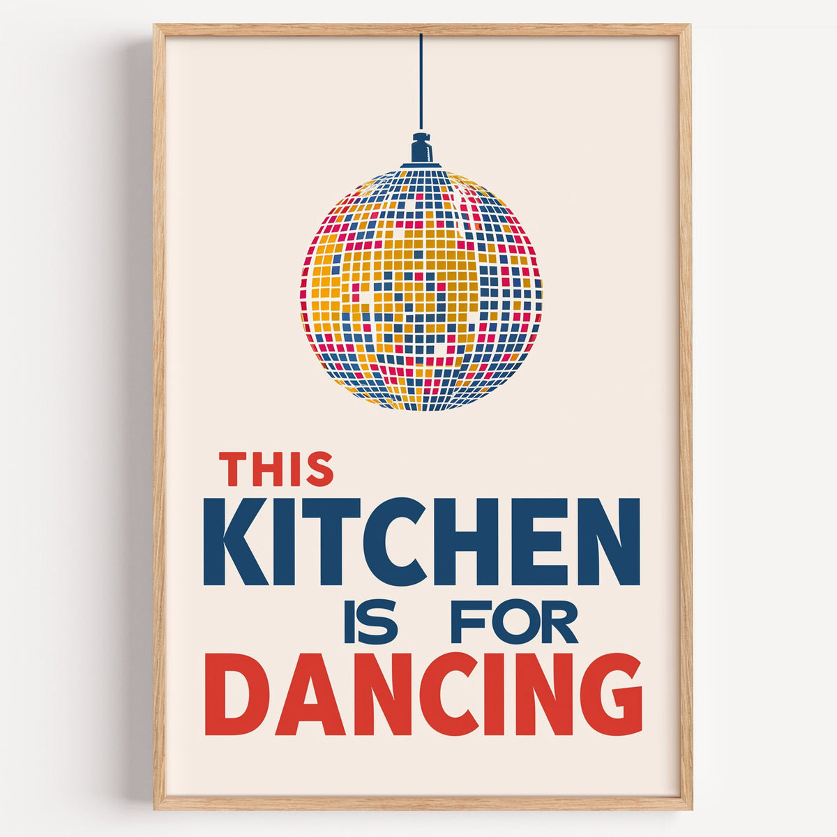 Kitchen Is For Dancing blue disco print in a light oak frame on a plain white wall
