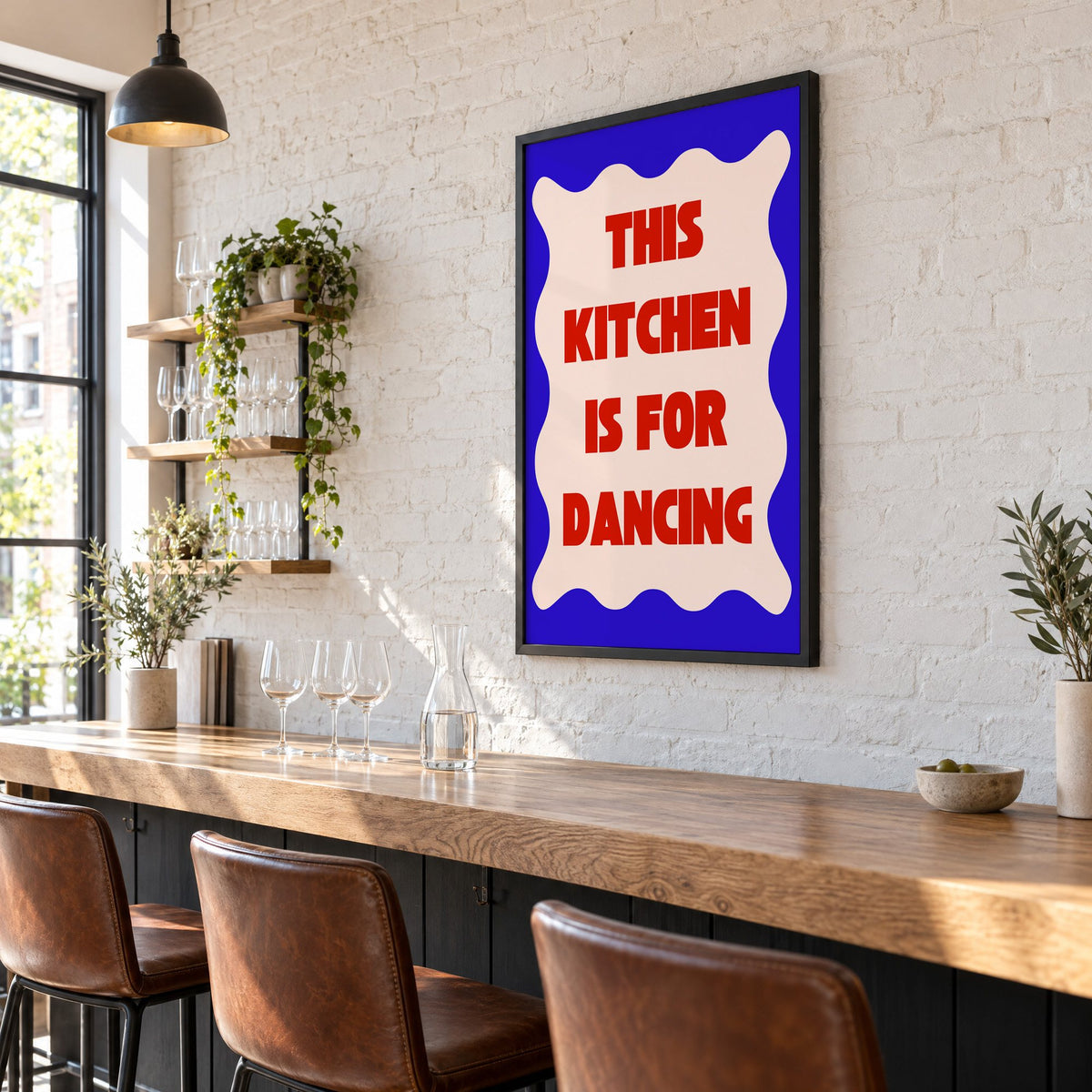 Kitchen Is for Dancing wavy blue print in a black frame on a white brick wall above a wine bar counter