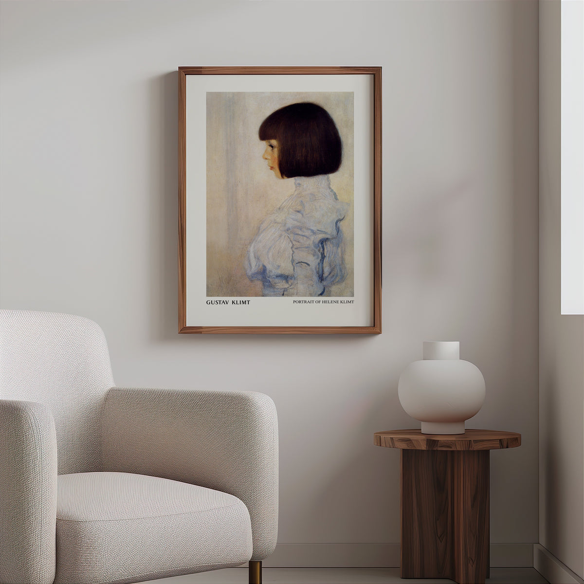 Klimt portrait print in a slim walnut frame above a bouclé armchair