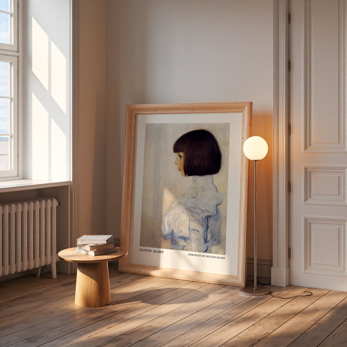 Klimt portrait print in a wide pine frame leaning by a sunlit window