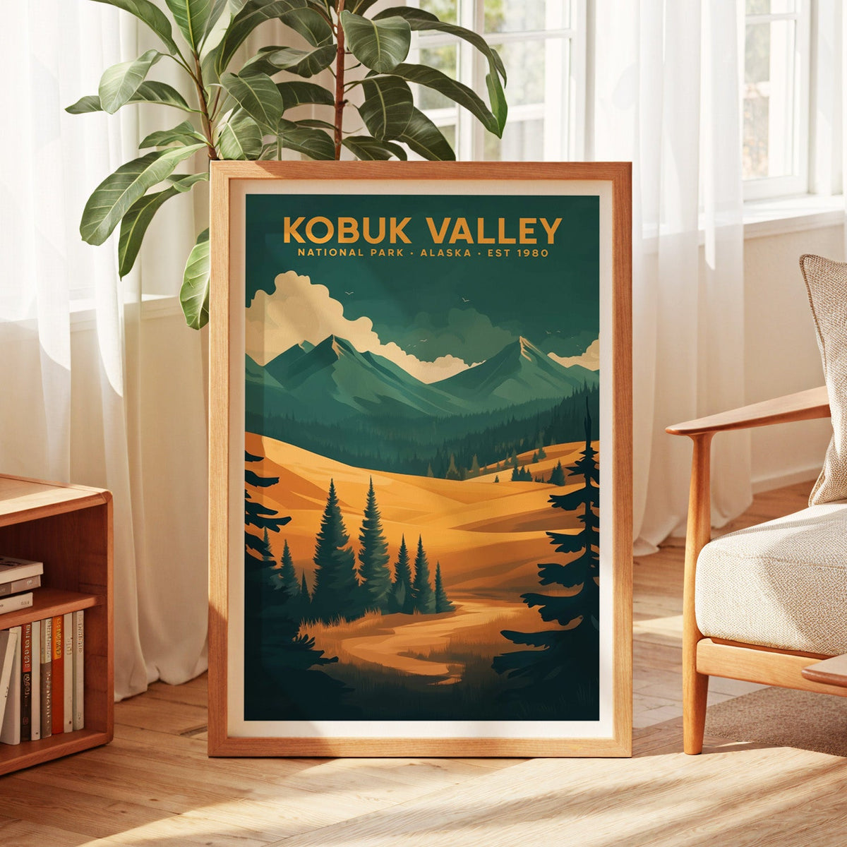 Kobuk Valley National Park print in an oak frame by a sunlit window with sheer curtains and a fig plant
