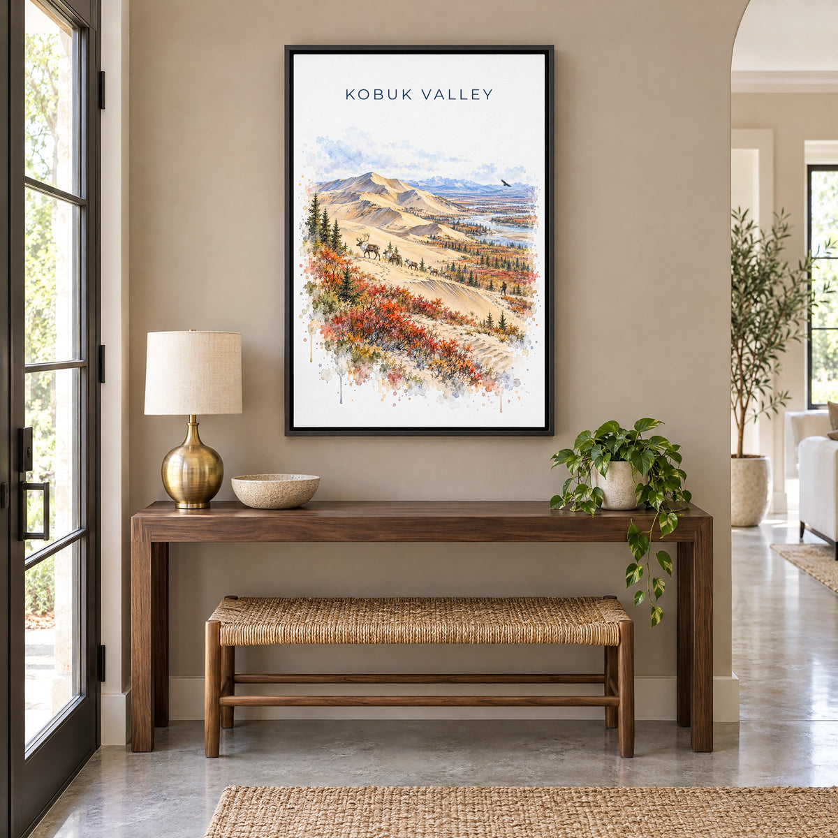 Kobuk Valley National Park watercolor print as a black floater canvas above a walnut console and woven bench in an entryway
