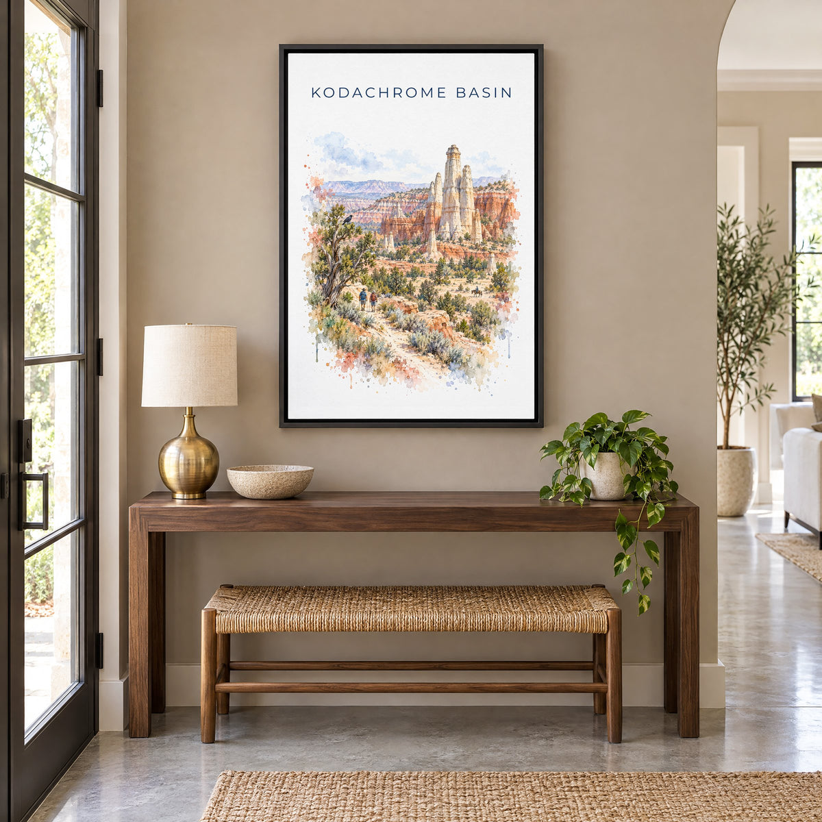 Kodachrome Basin State Park watercolor print as a black floater canvas above a walnut console and woven bench in an entryway
