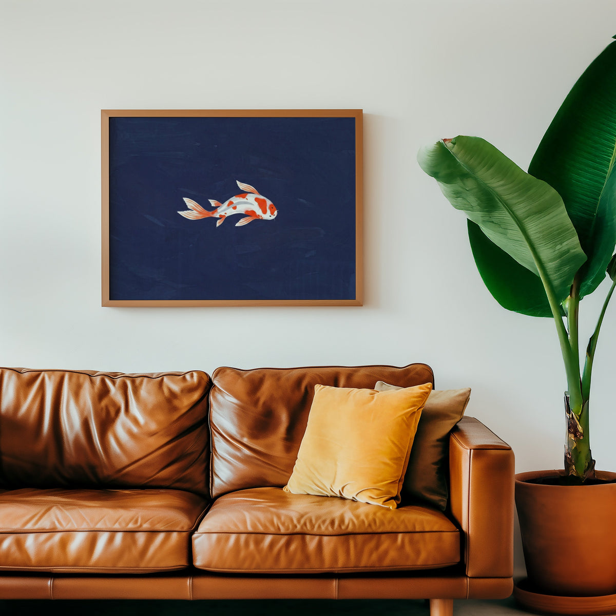 Minimalist koi print in an oak frame above a cognac leather sofa