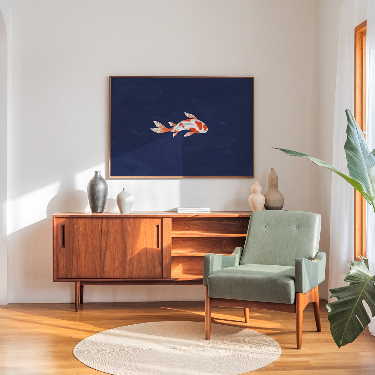 Single koi fish print in a walnut frame above a sideboard beside a sage armchair