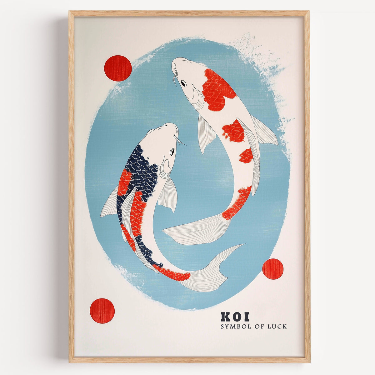 Two koi circling in blue oval print in a light oak frame on a plain white wall