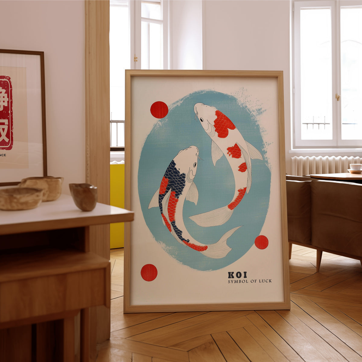 Two koi circling in blue oval print in an oak frame on the parquet floor of a sunlit living room