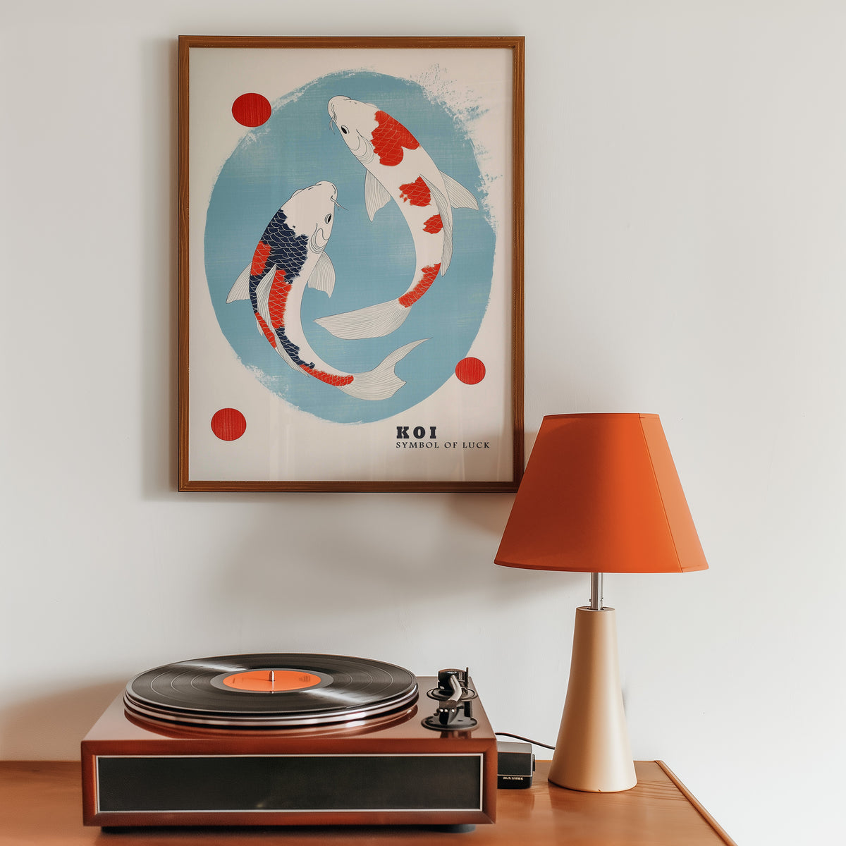 Two koi circling in blue oval print in a walnut frame above a sideboard with a record player