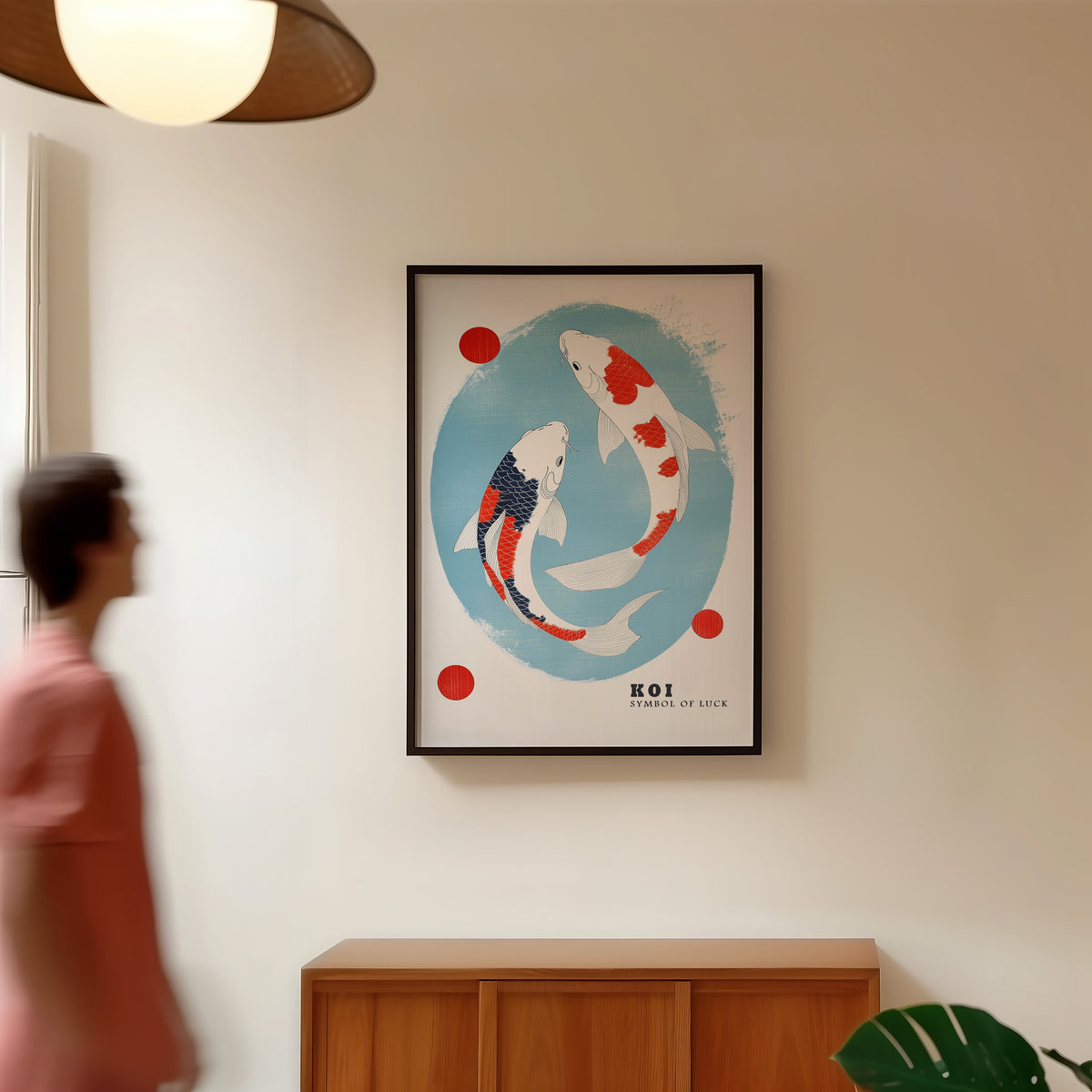 Two koi circling in blue oval print in a black frame in a hallway under a rattan pendant