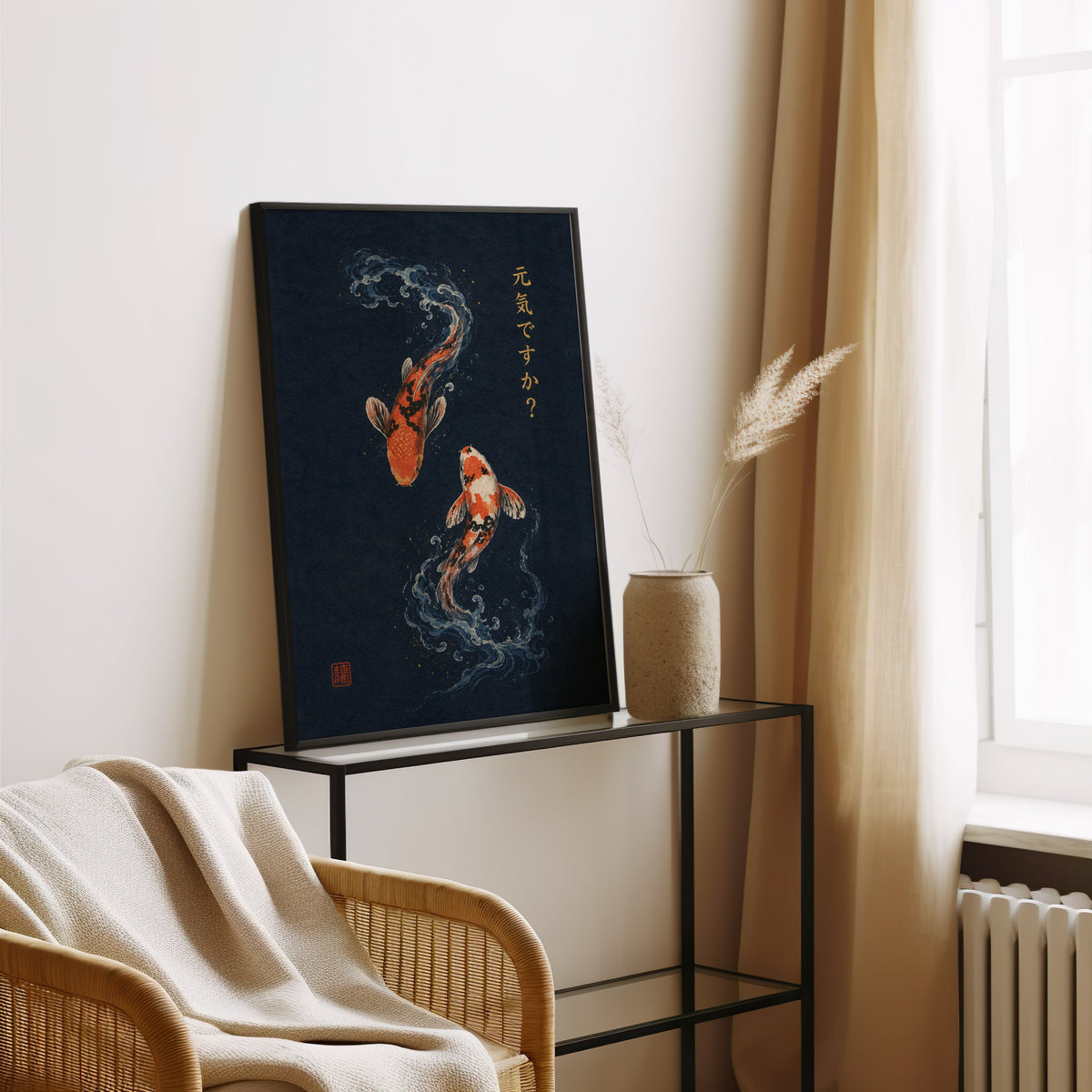 two koi fish on navy print in a black frame leaning on a glass console beside pampas grass