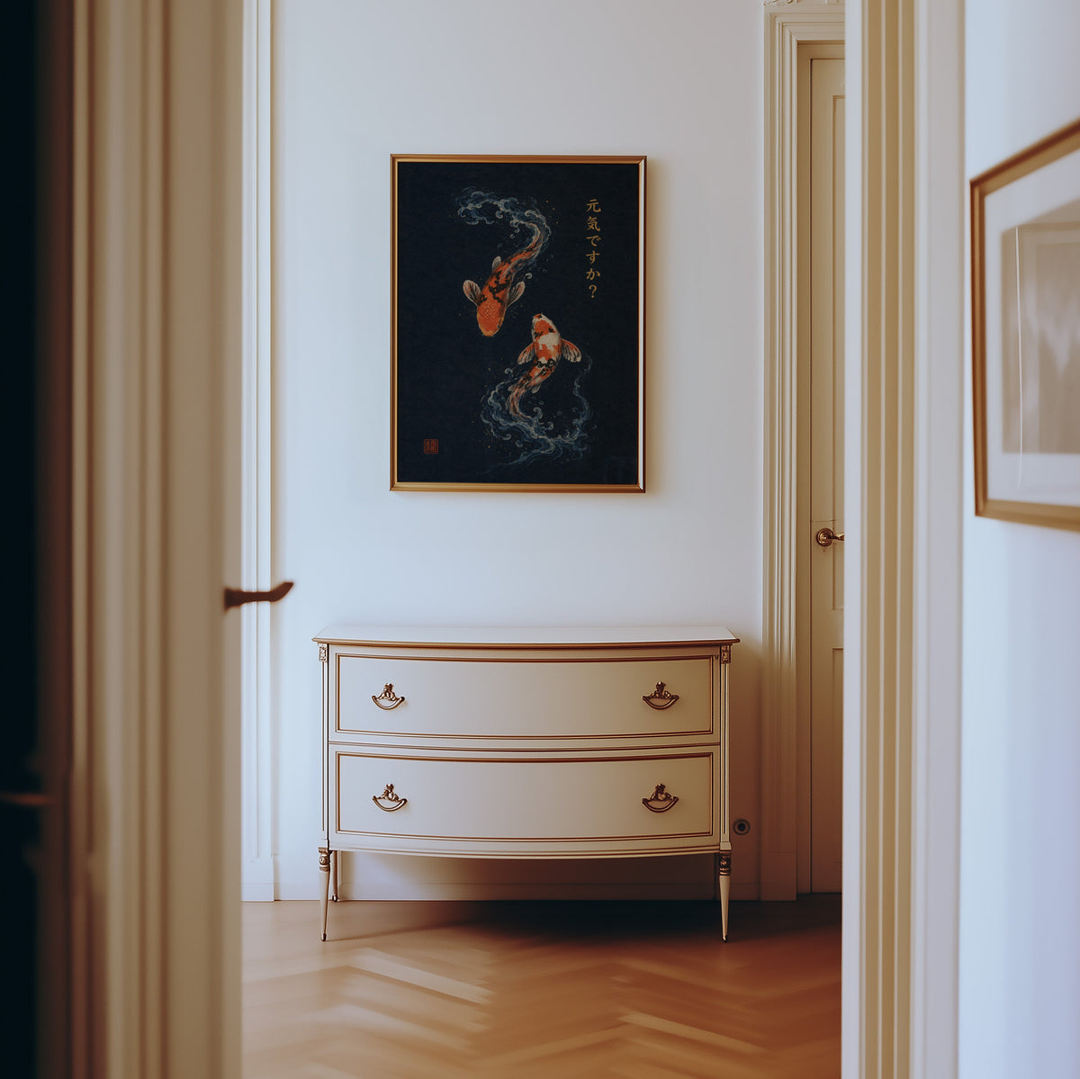 two koi fish on navy print shown in a gold frame in a hallway above a cream dresser