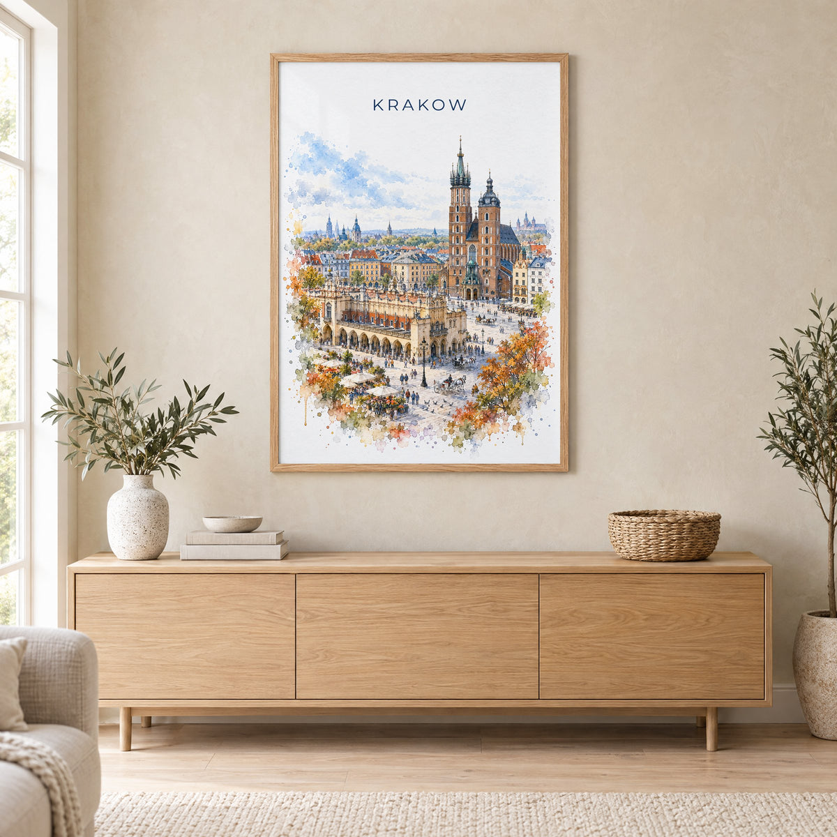 Krakow watercolor print in an oak frame above a light wood sideboard in a Scandinavian living room
