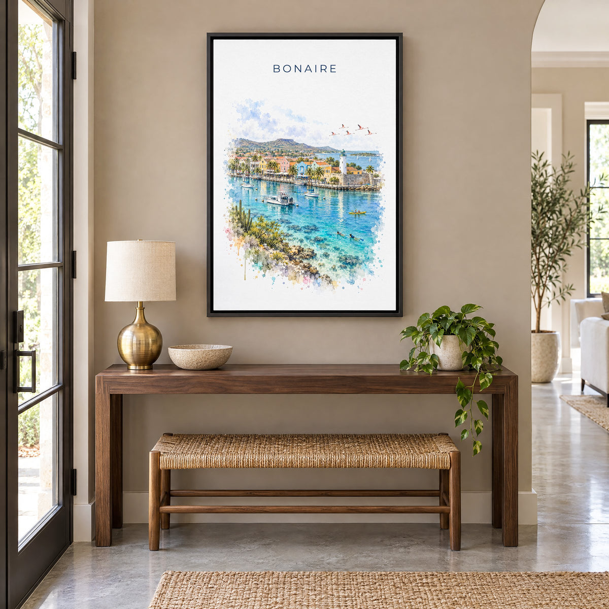 Bonaire watercolor print as a black floater canvas above a walnut console and woven bench in an entryway