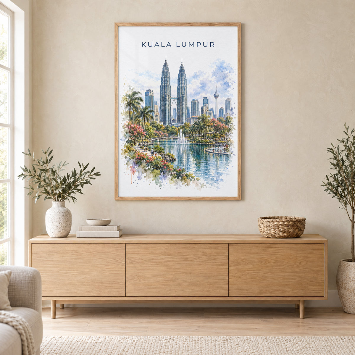 Kuala Lumpur watercolor print in an oak frame above a light wood sideboard in a Scandinavian living room