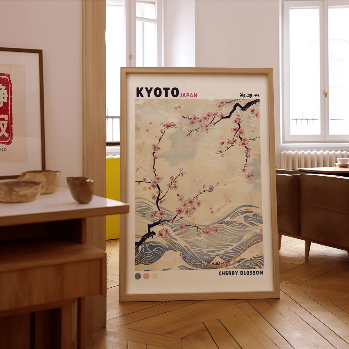 Kyoto cherry blossom and waves print in an oak frame on the parquet floor of a sunlit living room