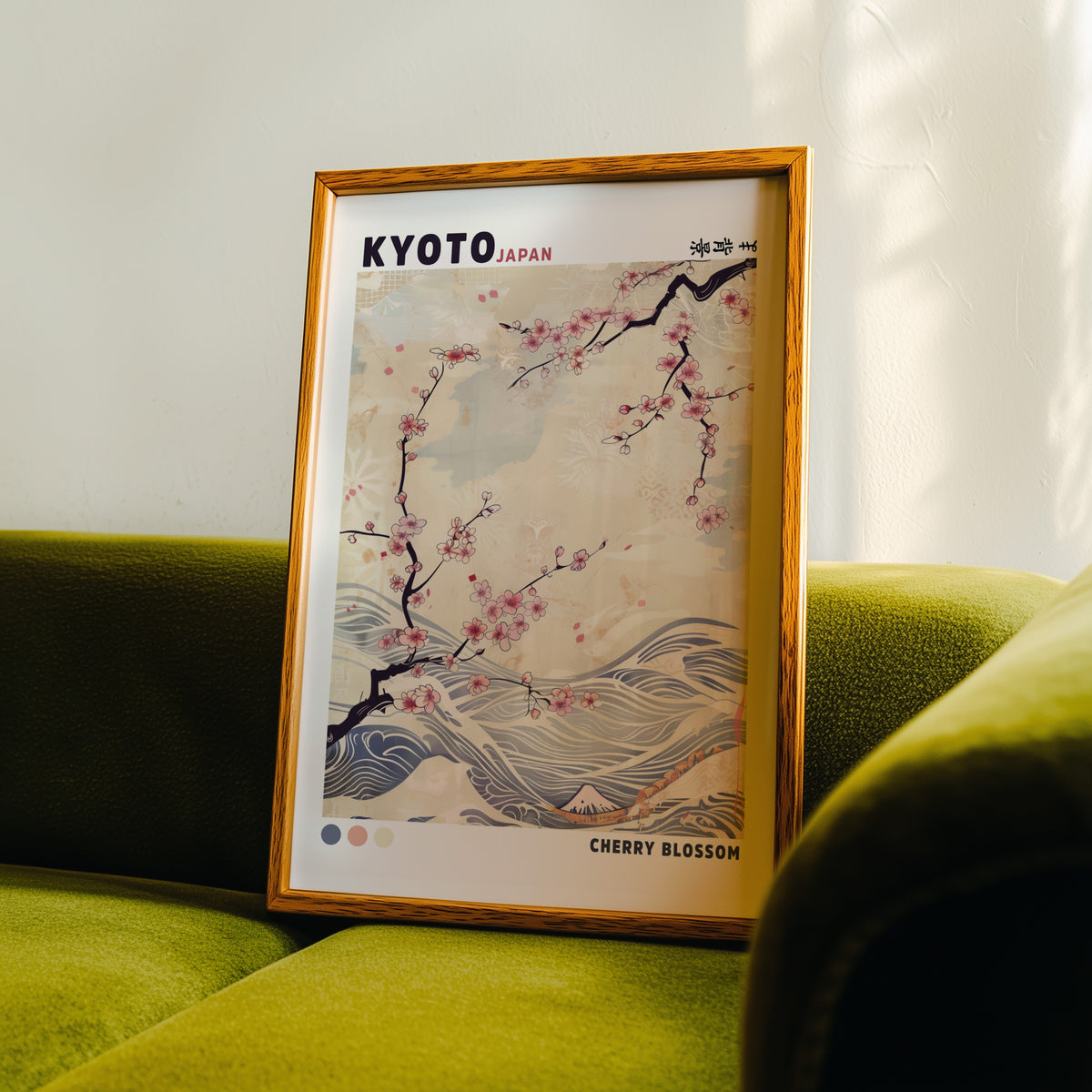 Kyoto cherry blossom and waves print in an oak frame propped on a green velvet sofa