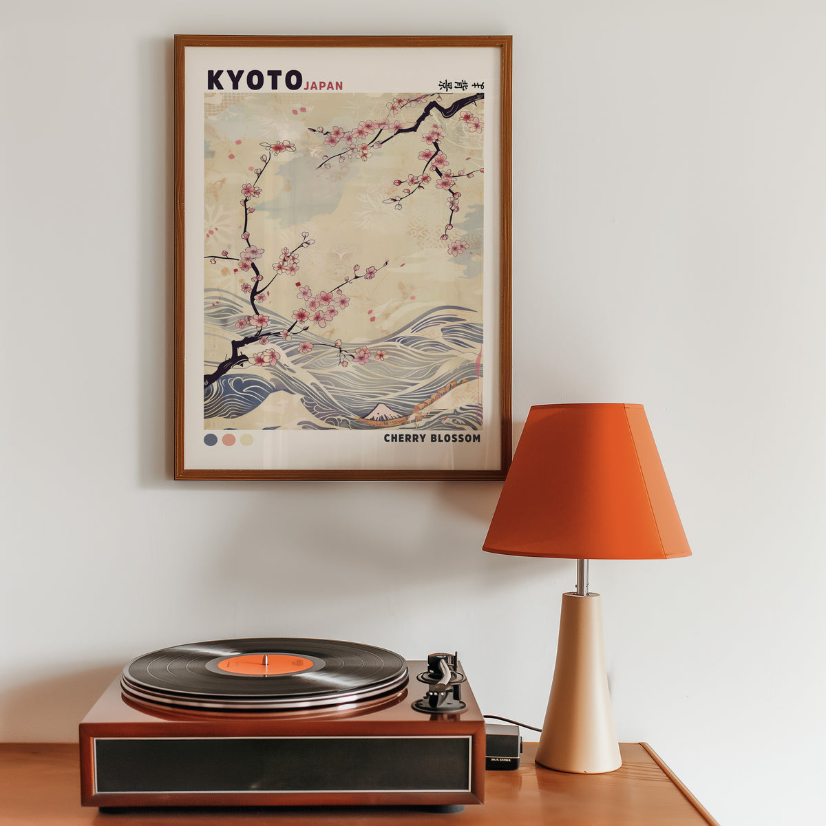 Kyoto cherry blossom and waves print in a walnut frame above a sideboard with a record player
