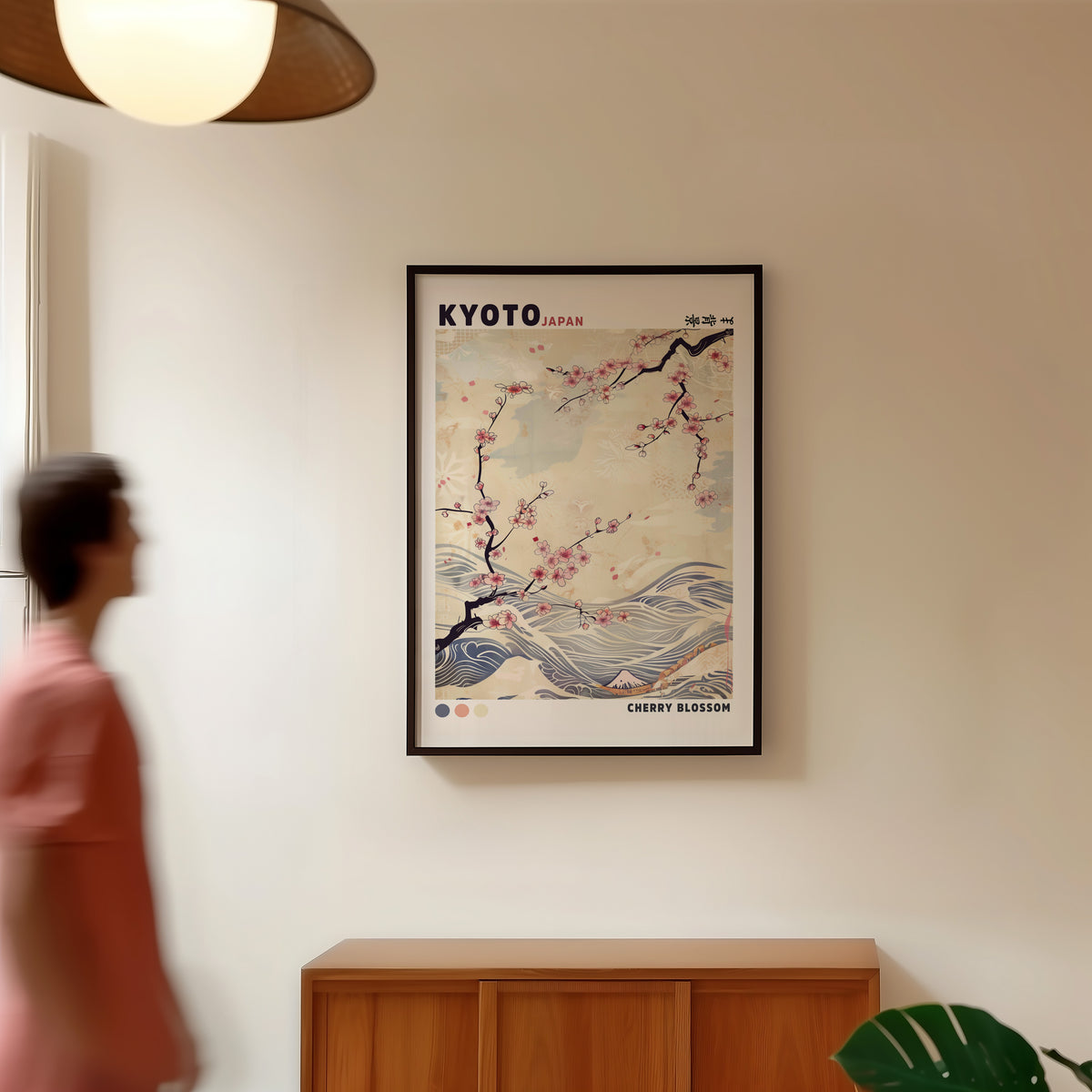 Kyoto cherry blossom and waves print in a black frame in a hallway under a rattan pendant