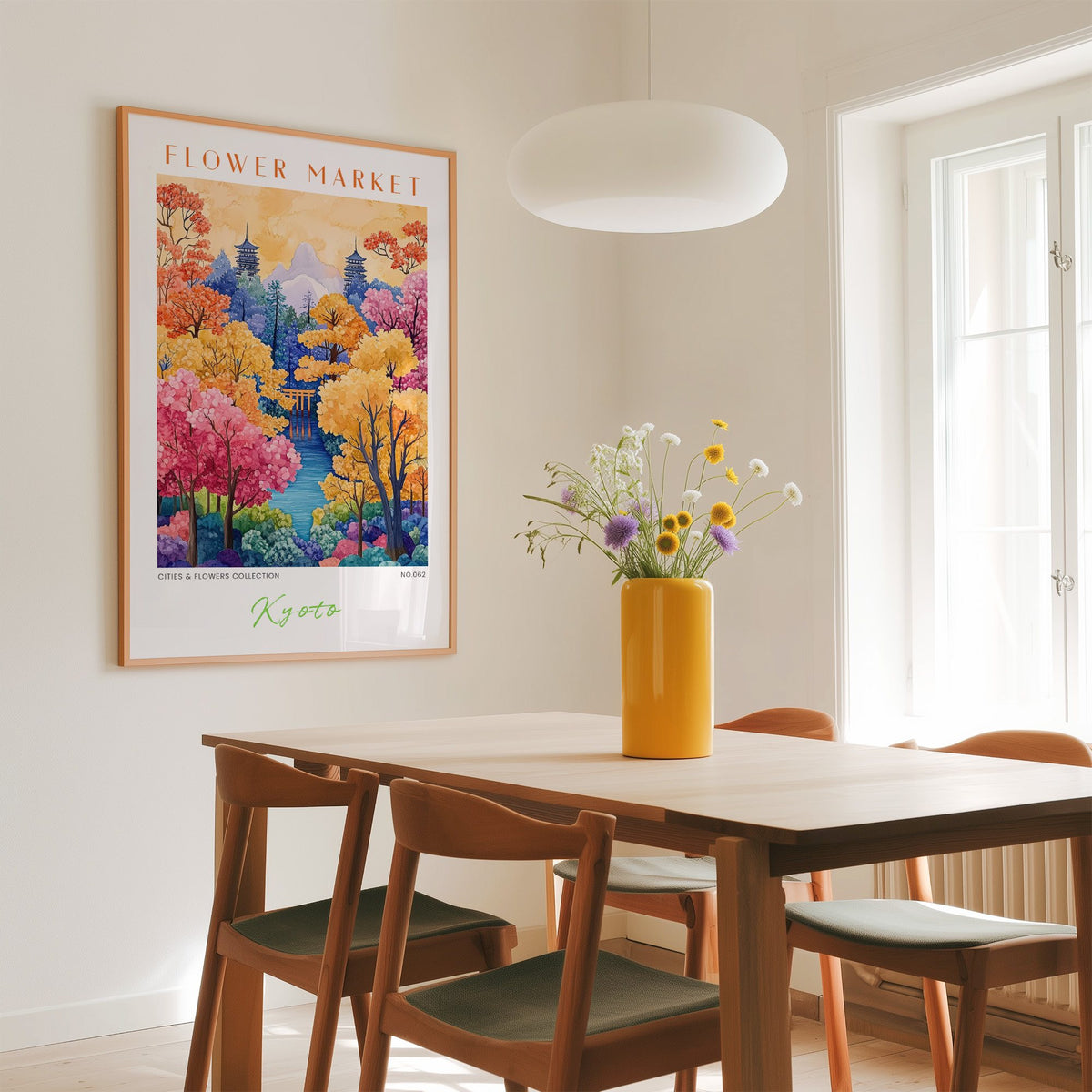 Kyoto flower market print in an oak frame above a dining table with a yellow vase and white pendant light