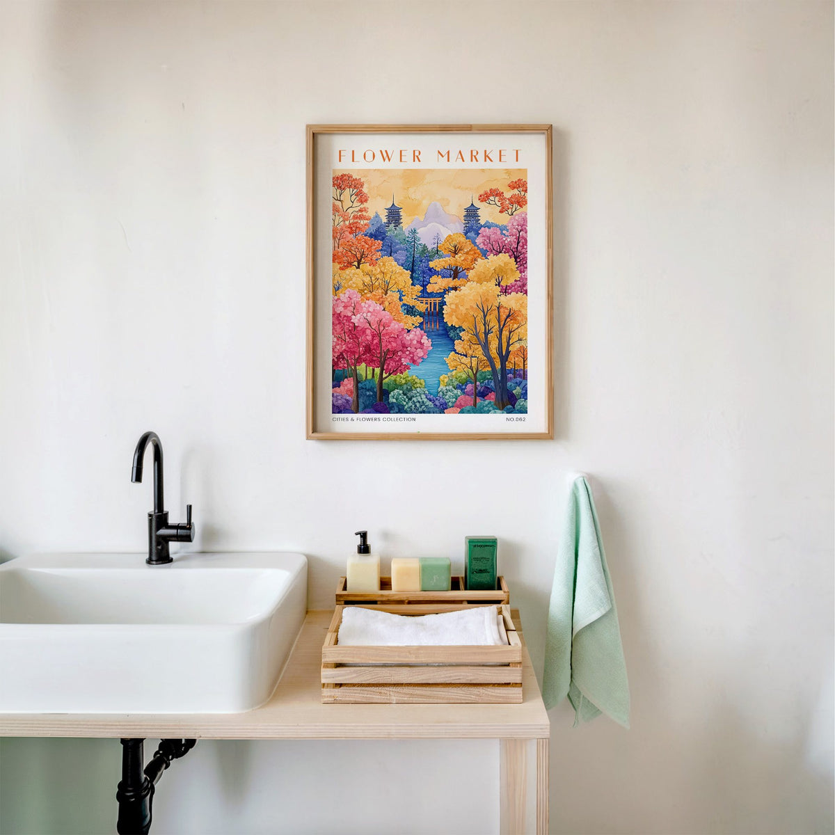 Kyoto flower market print in an oak frame above a white bathroom sink with folded towels