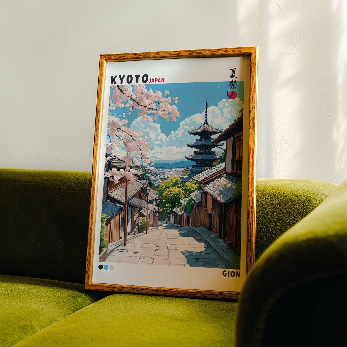Kyoto Gion cherry blossom street print in an oak frame propped on a green velvet sofa