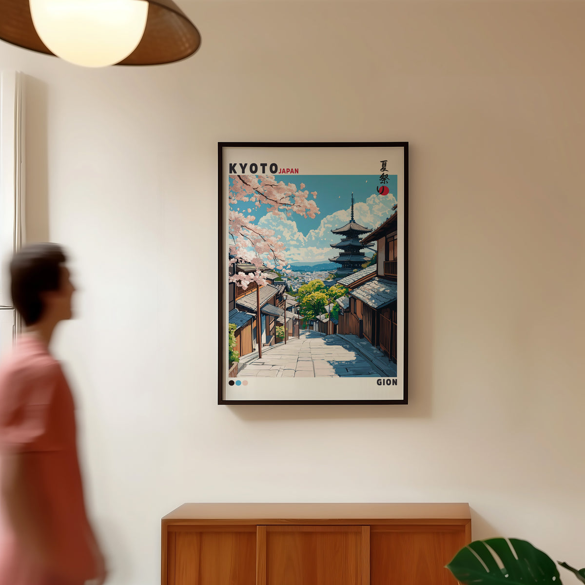 Kyoto Gion cherry blossom street print in a black frame in a hallway under a rattan pendant