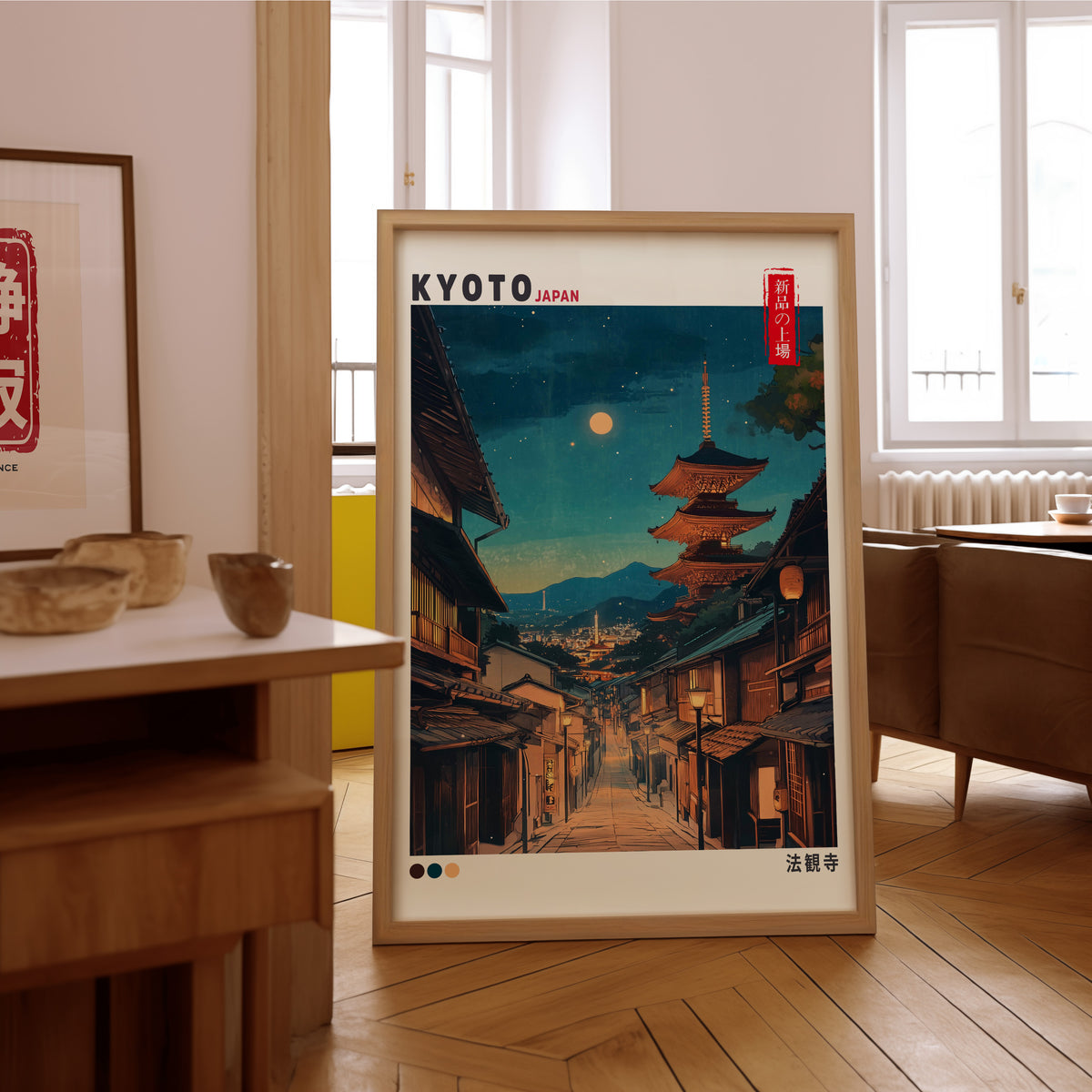 Kyoto night street and Yasaka pagoda print in an oak frame on the parquet floor of a sunlit living room