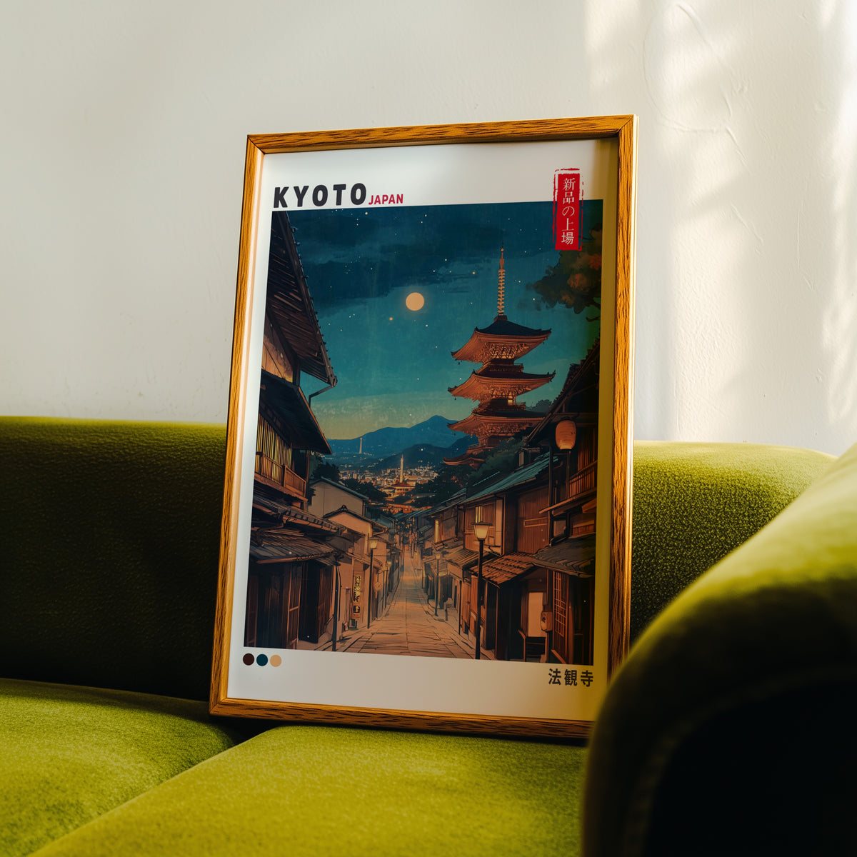 Kyoto night street and Yasaka pagoda print in an oak frame propped on a green velvet sofa
