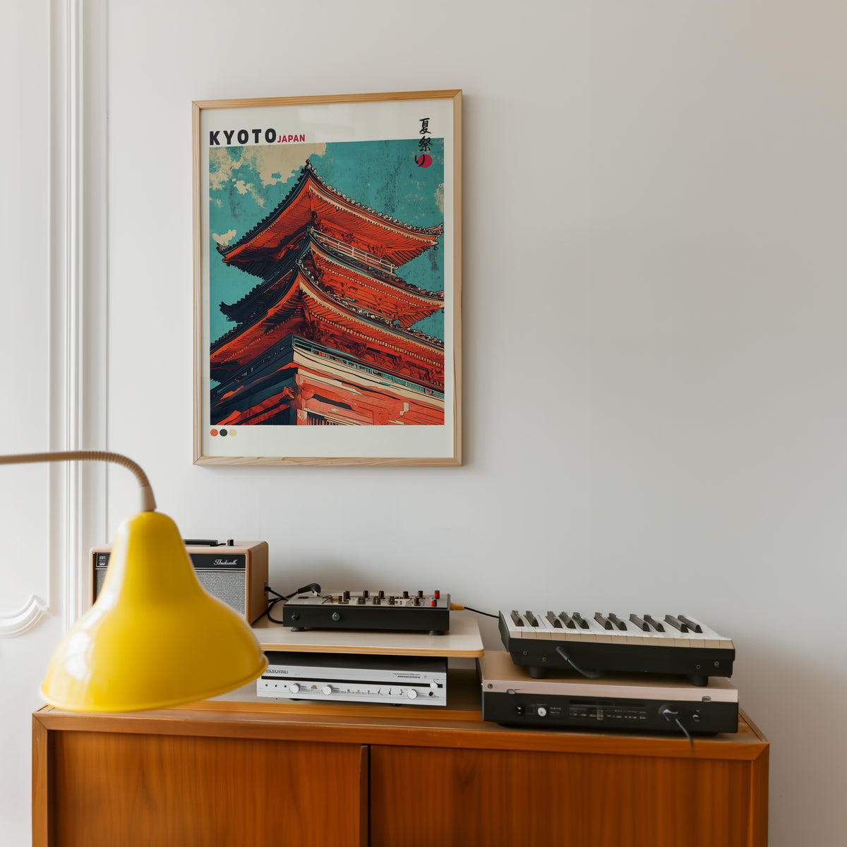 Red pagoda roofs under teal sky print in an oak frame above a teak sideboard with vintage hi-fi