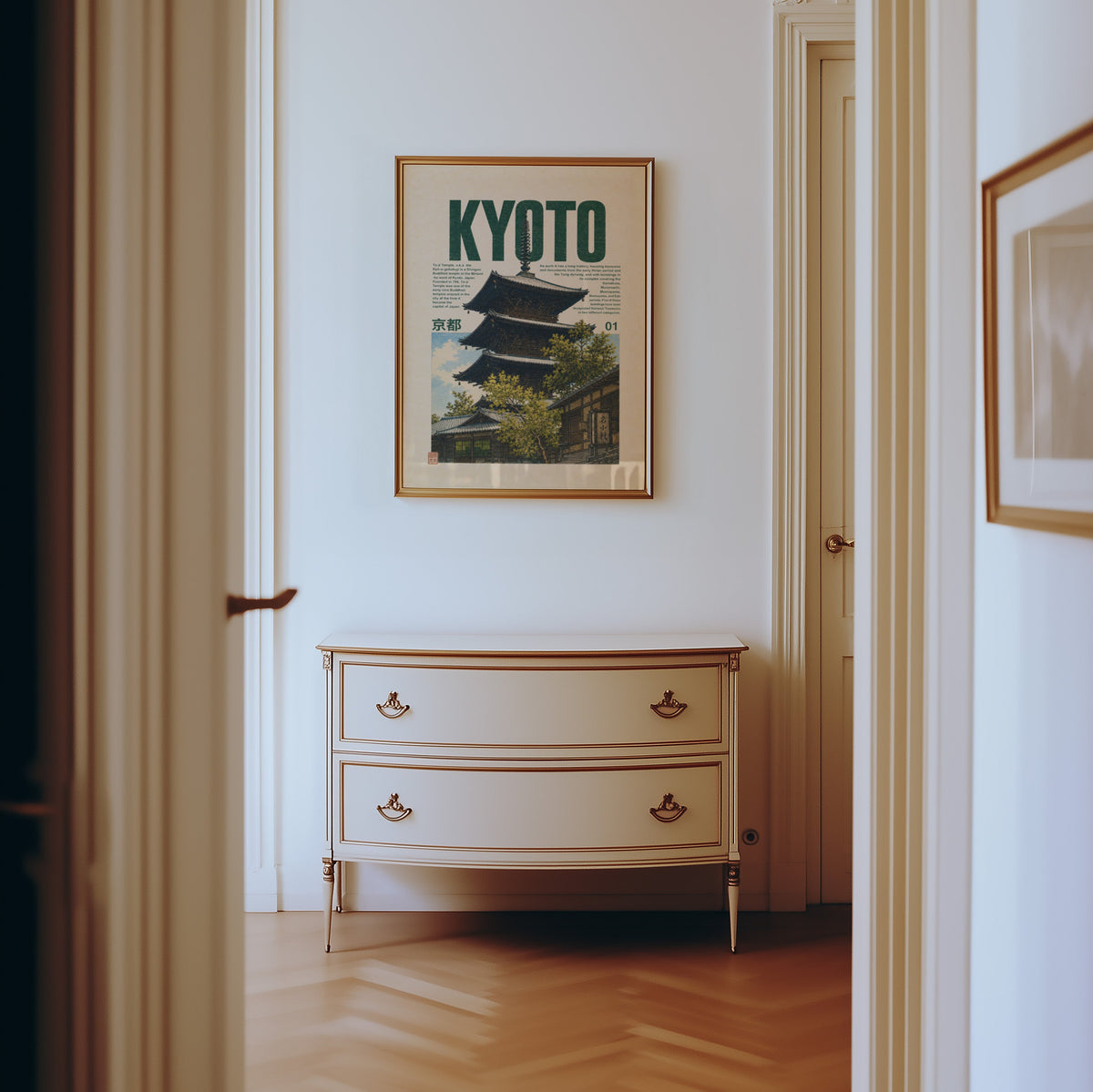 Kyoto pagoda travel poster print shown in a gold frame in a hallway above a cream dresser