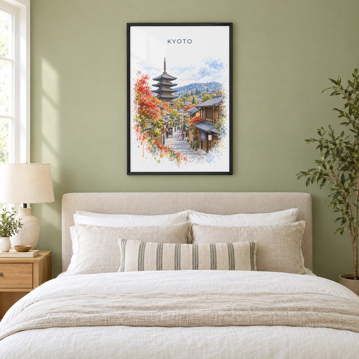 Kyoto watercolor print in a black frame above an upholstered headboard in a sage green bedroom