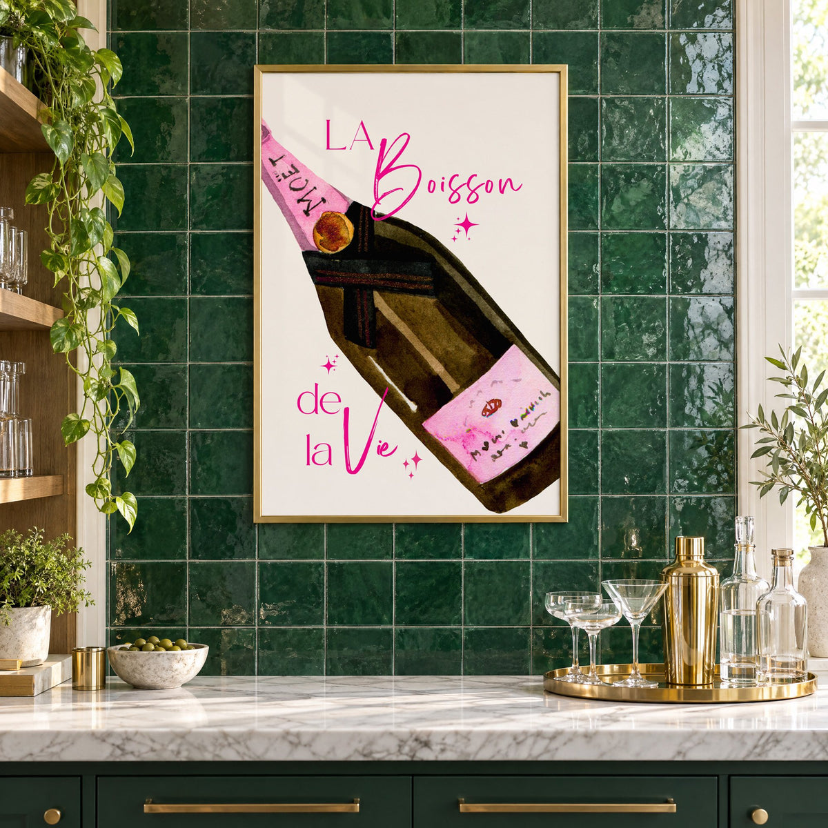 La Boisson champagne bottle watercolor print in a brass frame on emerald green tiles above a home bar with coupe glasses