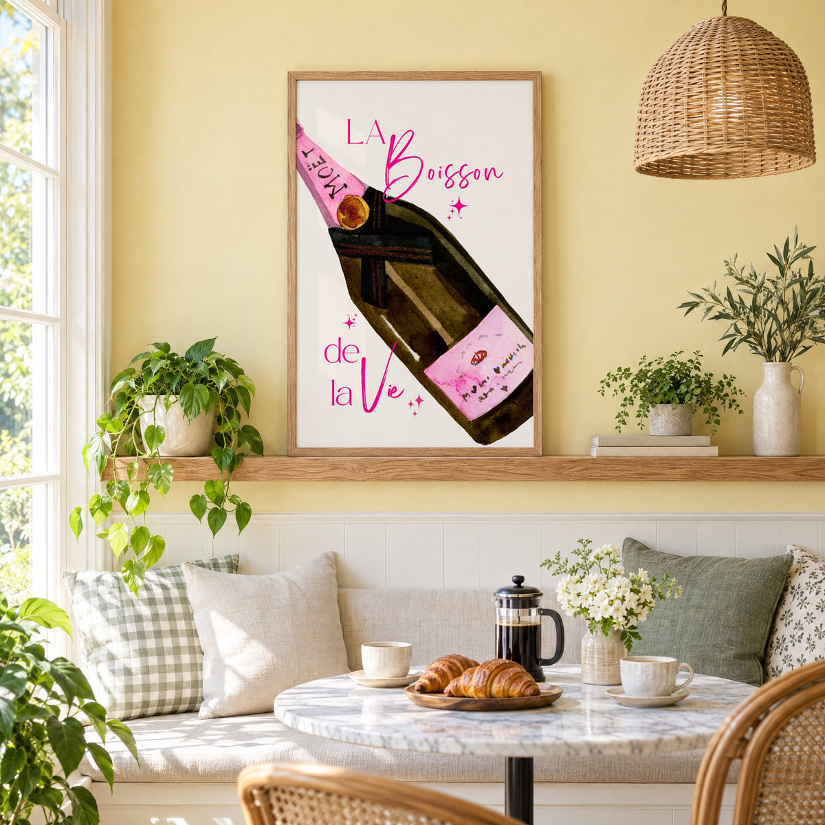 La Boisson champagne bottle watercolor print in an oak frame on a picture ledge above a sunny breakfast nook