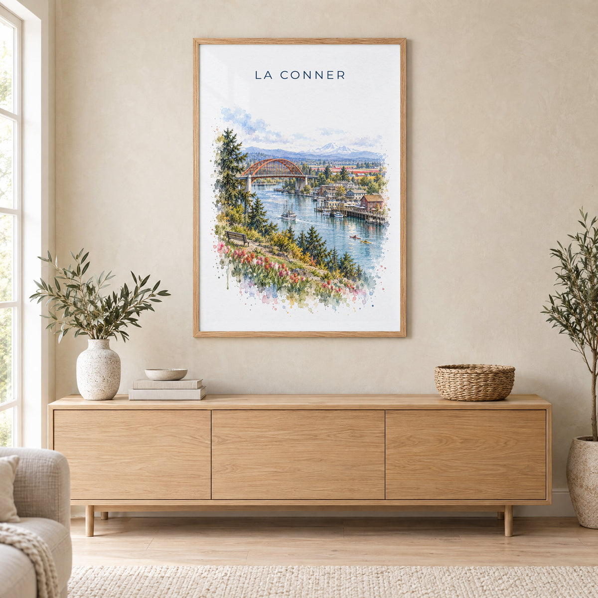 La Conner, Washington watercolor print in an oak frame above a light wood sideboard in a Scandinavian living room