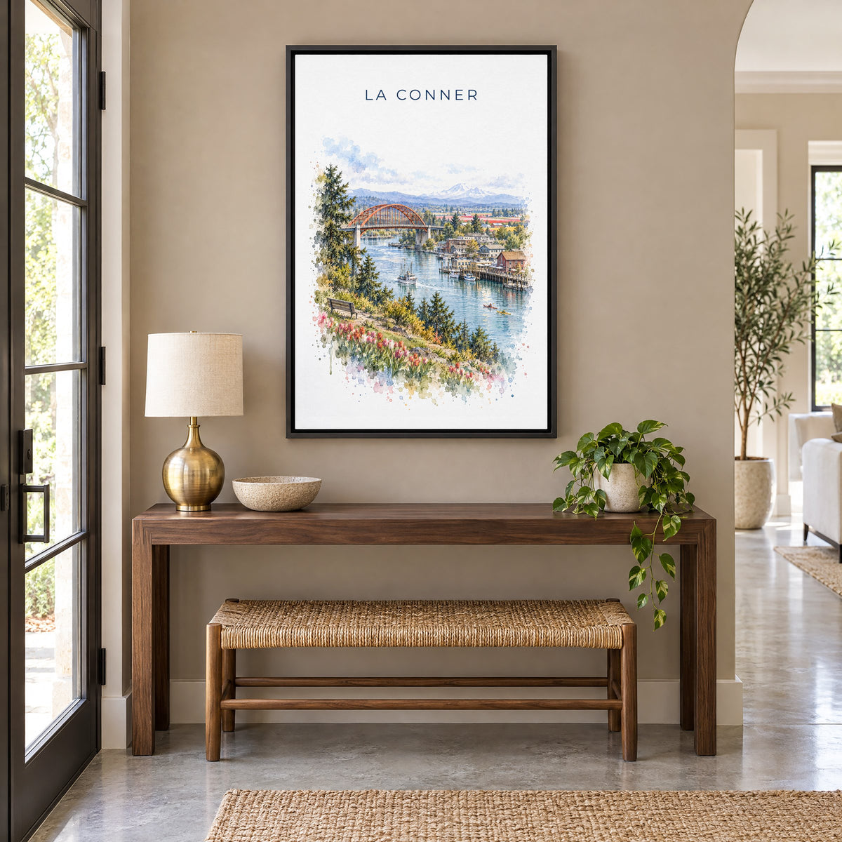 La Conner, Washington watercolor print as a black floater canvas above a walnut console and woven bench in an entryway