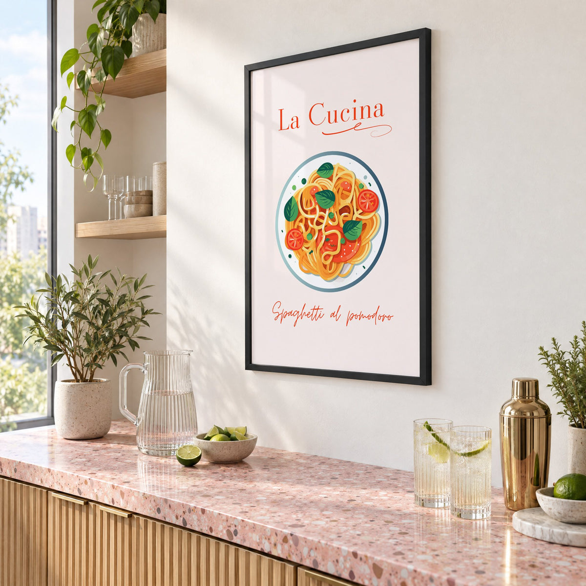 La Cucina spaghetti plate print in a black frame above a pink terrazzo cocktail counter with limes, seen at an angle