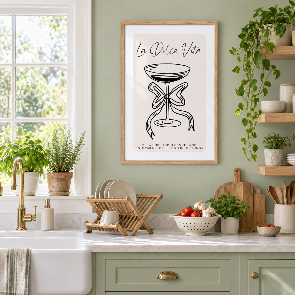 La Dolce Vita black line coupe print in an oak frame on a sage green kitchen wall beside a farmhouse sink and herbs